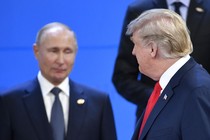Donald Trump looks at Russia's President Vladimir Putin as they take their places for a family photo during the G20 Leaders' Summit