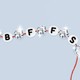 A red thread strung with beads that read "BFFS," interspersed with sparkling diamonds