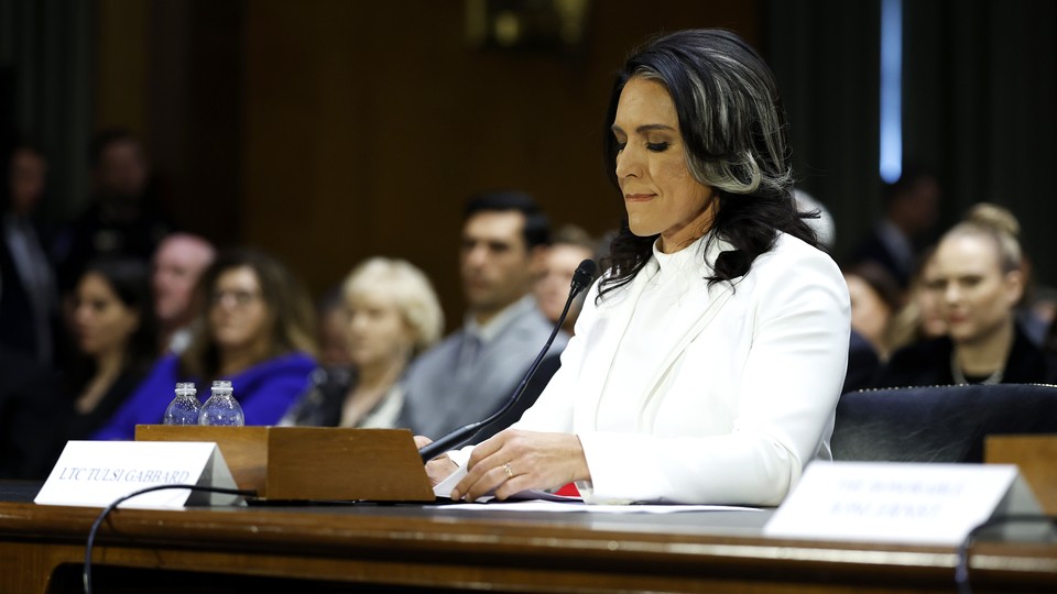 Tulsi Gabbard sits in front of a microphone during her Senate hearing