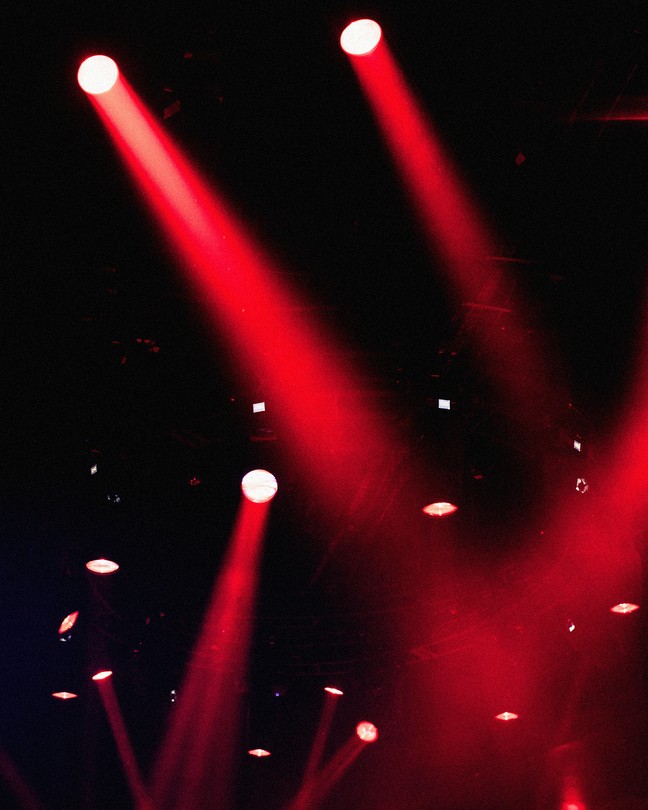 red spotlights shine against a black background