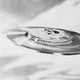 Black-and-white illustration of a flying saucer