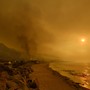 Heavy smoke covers the seaside enclave of Mondos Beach north of Los Angeles, California from wildfires in the region