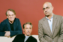 photo of Robert Downey Jr. sitting, flanked by Bartlett Sher in glasses and blue-green blazer on left and Ayad Akhtar in glasses and tan blazer on right