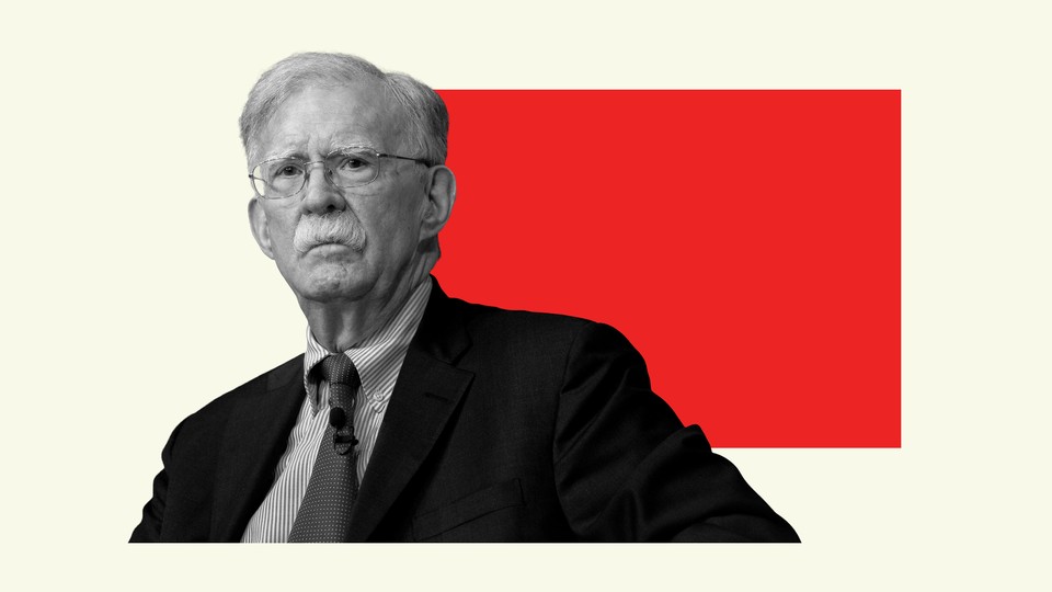 Black-and-white photograph of John Bolton with a red rectangle behind him