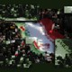 Heavily pixelated and distorted photograph of protestors surrounding a huge Iranian flag