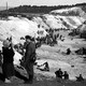 A black-and-white photo of Soviet prisoners of war covering a mass grave at Babi Yar