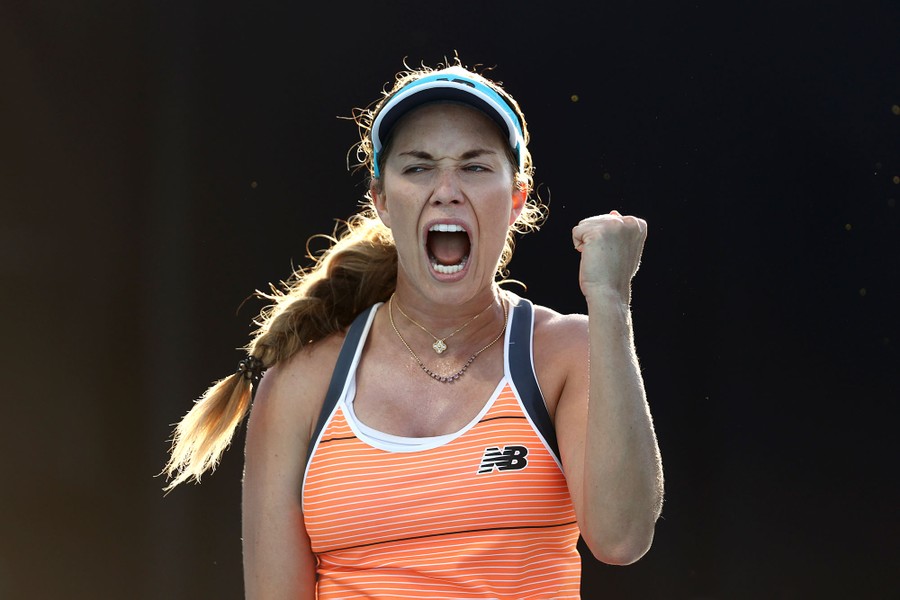 Danielle Collins shouts and holds up a fist.