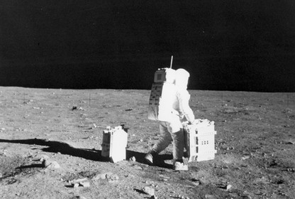 Buzz Aldrin moves equipment on the moon.