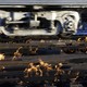 A train moves past rails surrounded by flames.