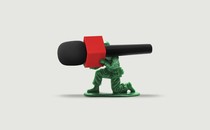 A toy soldier holds a microphone like a machine gun