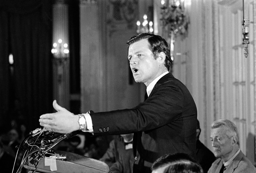 Senator Edward M. Kennedy speaks before a podium.