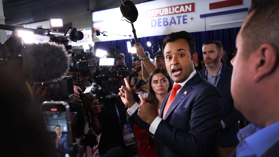 Photo of Vivek Ramaswamy surrounded by media in the debate spin room