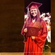 A student smiles, holds a diploma, and wears a graduation cap and gown. The words "What my students taught me" are written next to her.