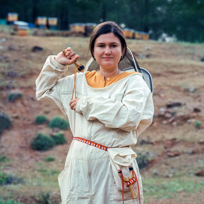 woman dressed in traditional bee keeping gear