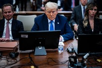 Trump seated next to his lawyers