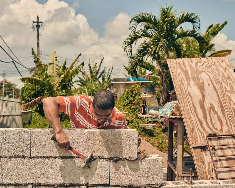 man rebuilding his home in San Isidro