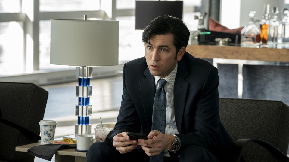 Greg Hirsch (played by Nicholaus Braun) sits in his new suit, and his new loft, in New York City.