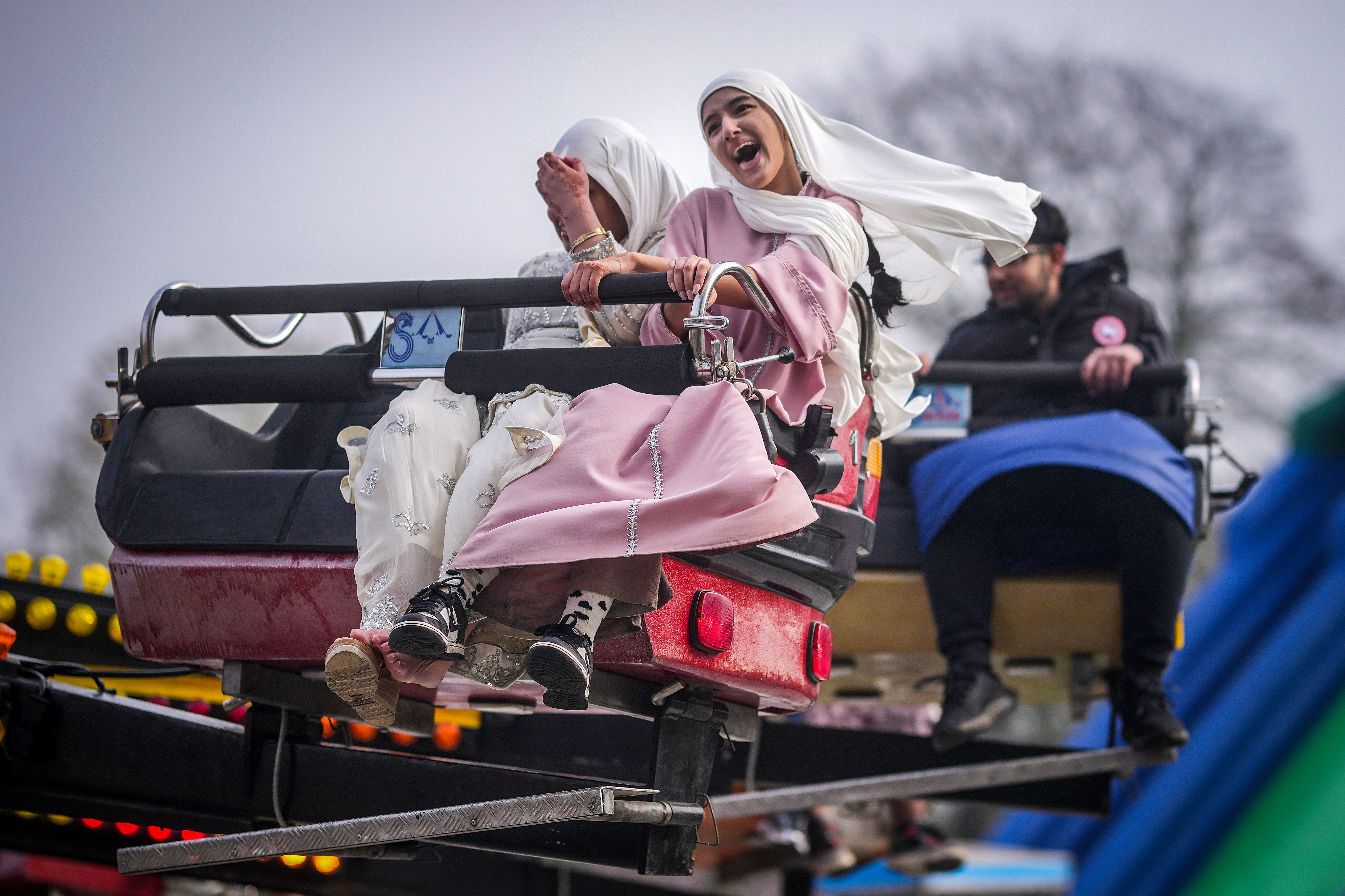 People laugh, enjoying an amusement park ride.