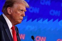 Donald Trump stands in front of a microphone during CNN's presidential debate