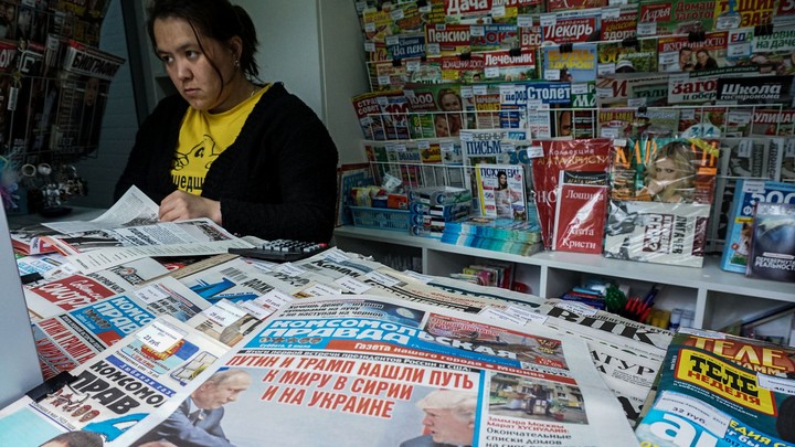 A woman looks at newspapers at a Moscow newsstand in 2017.