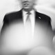 A shaken, overexposed black-and-white photo of Donald Trump speaking