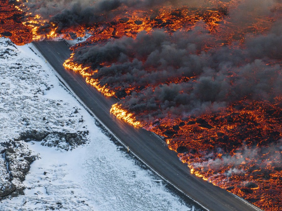 A broad swath of lava flows over a road.