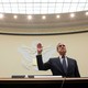 Robert Mueller lifts his right hand up while swearing in to testify in front of the House Judiciary Committee.