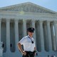 A police officer stands outside the U.S. Supreme Court building