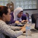 Students sit at laptop computers