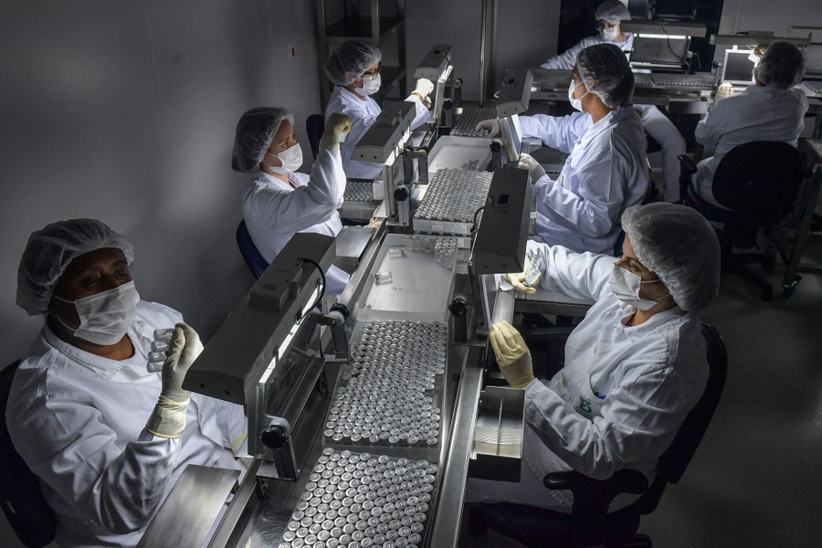 Workers handle hundreds of vials of vaccine.