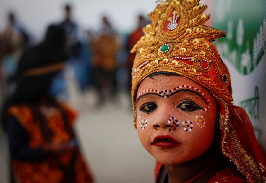 A close view of a young girl in traditional Hindu makeup and costume
