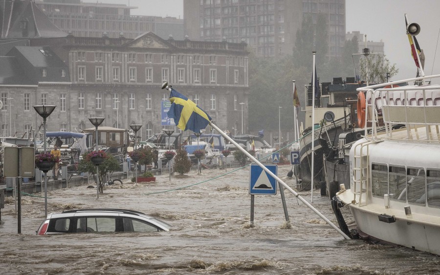 A river nears the top of its banks during a heavy flood in a city.