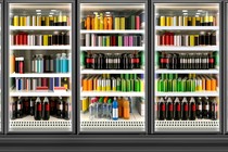 Juice cans and bottles in fridge at supermarket