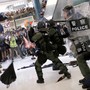 Hong Kong riot police use pepper spray to disperse protesters in a suburban shopping mall.