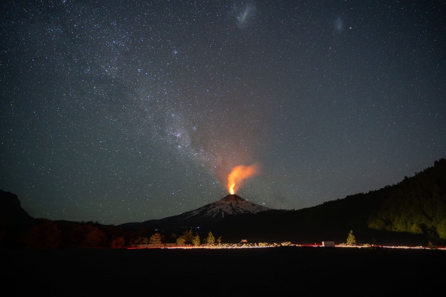 An active volcano seen beneath a starry sky