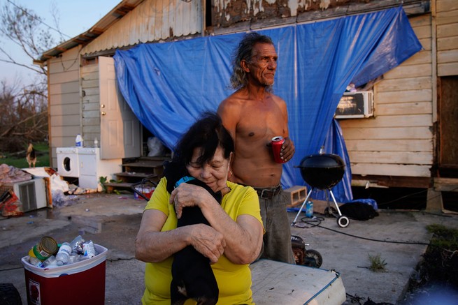 Residents outside a damaged home in Dulac, Louisiana