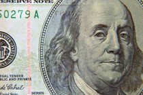 A close-up view of Benjamin Franklin's face on a $100 bill