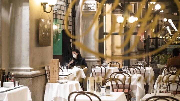 A tourist wears a protective mask at Biffi restaurant in Milan, Italy.