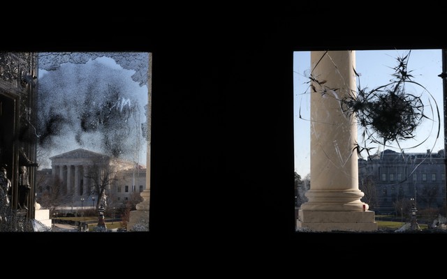 Windows at the Capitol pocked with bullet holes