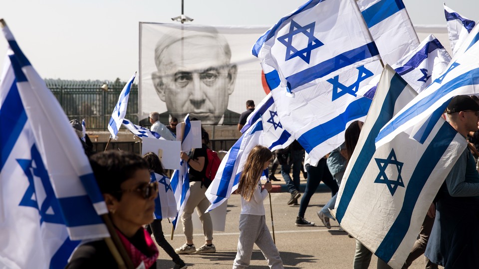 Protesters waving Israeli flags