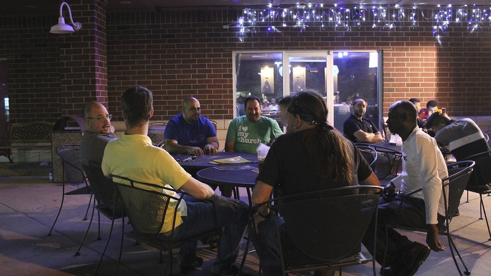 Nashwaan Saddoon, Amjad Arafeh, Shane Lakatos, and other men participate in a monthly Sawa gathering in Toledo, Ohio.