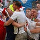 England soccer fans embrace and celebrate.