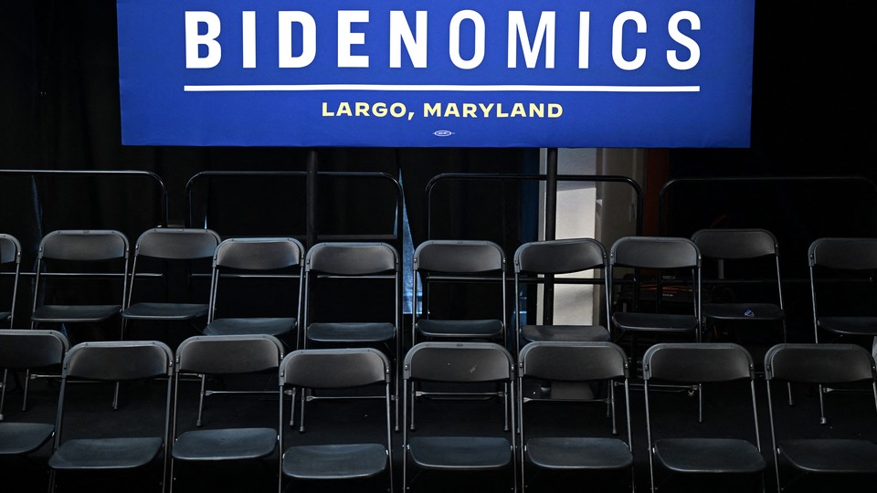 Chairs sitting in rows with a Bidenomics sign above them