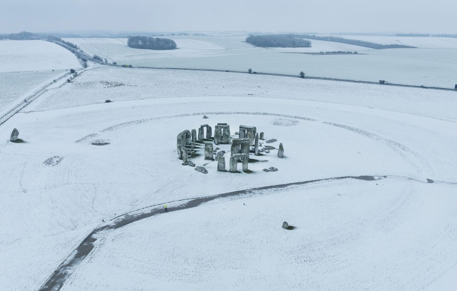 An aerial view of Stonehenge covered in snow