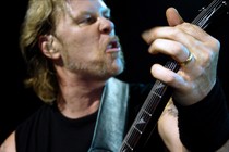 James Hetfield plays guitar onstage