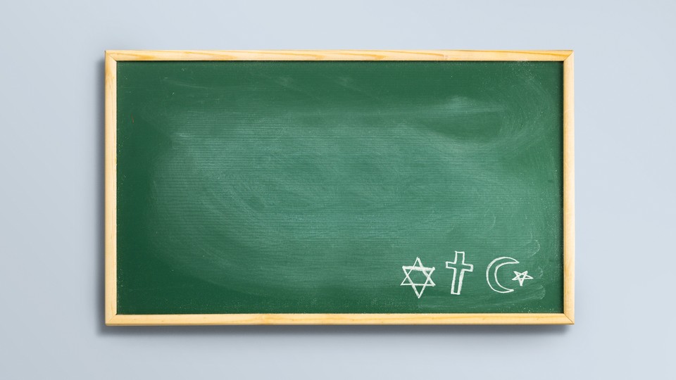 Picture showing green chalkboard with drawings of the Jewish star of David, the Christian cross, and the Muslim star and crescent.