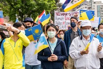 Taiwanese hold up Ukrainian flags at a rally.