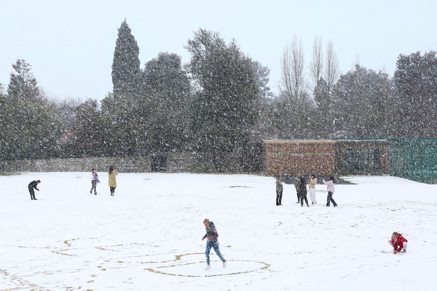 Children play in the snow at a school in South Africa.