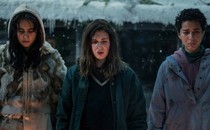 Three girls in the TV show "Yellowjackets" standing in the cold