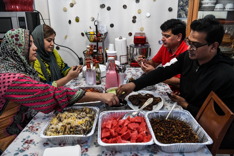 A family  shares a meal in their home.